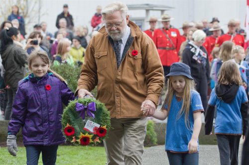 John Silins places sponsored wreaths, on behalf of Saltair District Ratepayers Association, that were laid at the Ladysmith and Chemainus Cenotaphs, respectively.